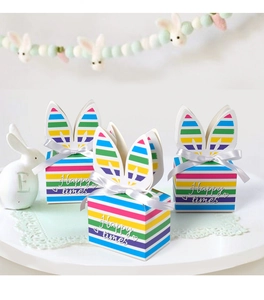 Detail of colorful striped Easter gift box with rabbit ears and white silk bow accent
