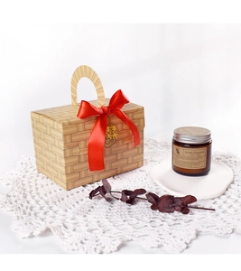 Detail of bamboo weave pattern gift box with red silk ribbon and golden Xi character charm