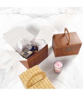 Detailed view of woven-print gift boxes with handles on a marble surface showing usage