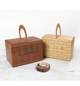 Detail of faux woven gift boxes with vintage handles and elegant printed textures