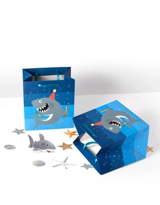 Detailed view of blue gradient shark birthday gift bags with satin handles and plush charm