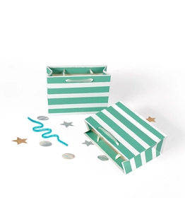 Detail of green striped paper gift bag showing folding structure and satin ribbon handle