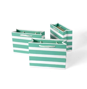 Detail view of horizontal mint green striped paper gift bags with satin ribbon handles