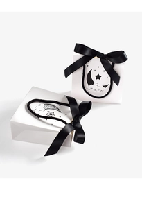 White gift bags with black ribbon bow featuring celestial moon and star illustration