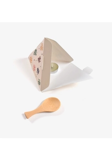 Close-up of a white triangular blessing gift box with colorful Fu characters and a tealight