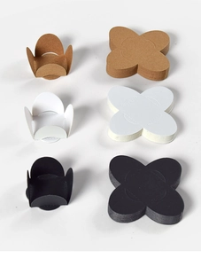 Three colors of folded floral paper truffle liners for Valentine chocolate packaging