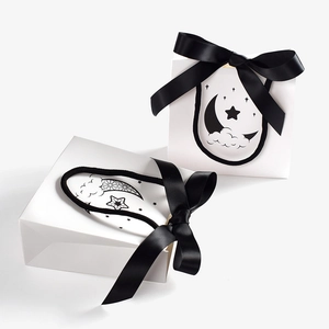 Minimalist white gift bags with black satin bow and moon star prints for business use