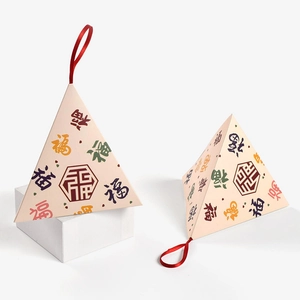 Traditional pyramid gift box with festive red ribbon and calligraphy for Dragon Boat Festival