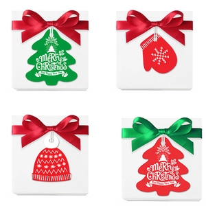 Set of Christmas decorative tags with trees and gloves on festive gift boxes