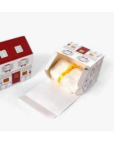 Detail of house-shaped gift box with red roof and interior textile with yellow ribbon