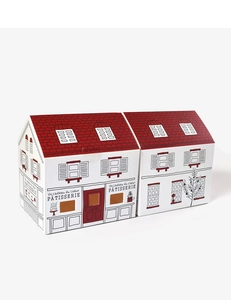 Detail of house-shaped white bakery gift box with red roof and French line art text