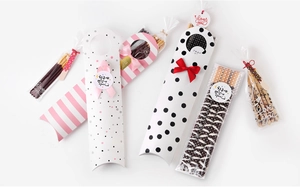 Detailed view of pink striped long biscuit gift boxes with Korean greeting stickers