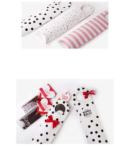 Macro detail of long cookie gift boxes with heart tags and decorative ribbon accents