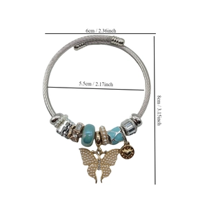 Detail showing dimensions of silver beaded bangle with pearl bow and blue charms