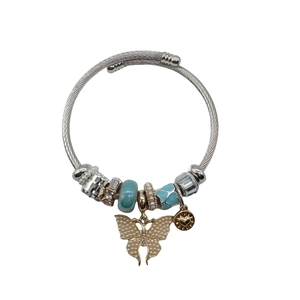 Silver twisted bangle with blue glass beads and a gold butterfly pearl charm