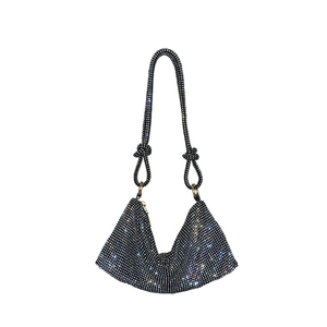 Exquisite detail of black rhinestone-studded underarm bag with elegant knot strap