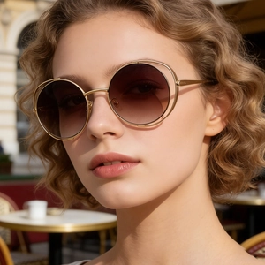 Detailed close-up of premium hollow gold double-frame sunglasses with gradient brown lenses