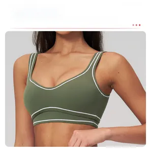 Detail of dark green sports bra with white contrast piping and removable padding
