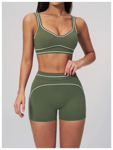 Detail of olive green yoga set with high waist shorts and contrast stitching details