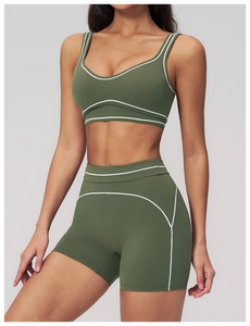 Detail of olive green sports bra and high-waisted shorts with white contrast stitching