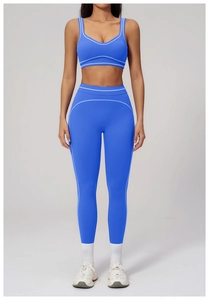 Macro detail of high-stretch blue yoga set with contrast white side stripe stitching
