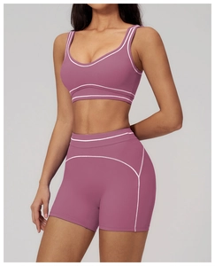 Close-up of contrast stitching on mauve high-stretch yoga bra and shorts set