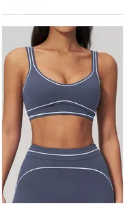 Detail of teal blue sports bra and yoga leggings with white contrast double stripes