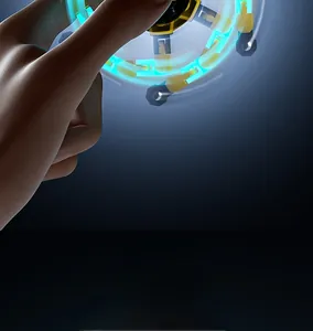 Action shot of deformable glowing fidget spinner creating blue light rings during rotation