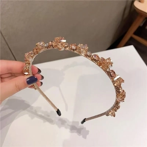 Close-up of rose gold metal headband with sparkling champagne crystal rhinestones