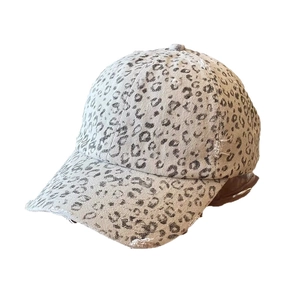 Distressed leopard print baseball cap with frayed brim and vintage streetwear style