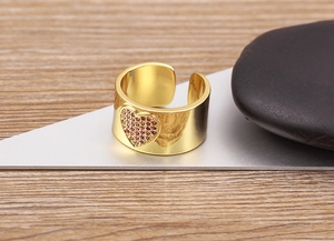 Macro shot of 18K gold plated adjustable heart ring with pink zircon pavé setting
