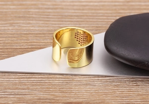 Detail of 18K gold plated wide ring band with pink zircon heart stones on the inner side