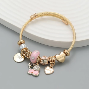 Golden cable bracelet with pink elephant charm, sparkling beads and engraved heart pendants