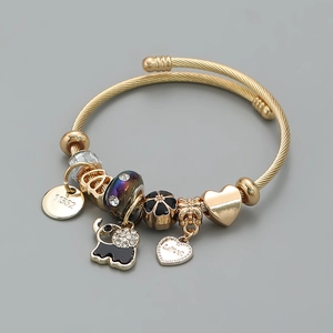 Detailed macro view of a gold elephant charm bracelet with diamond accents and love heart