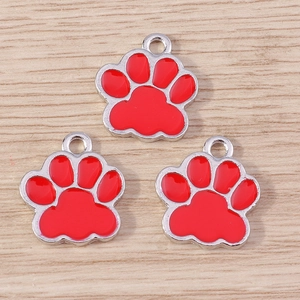 Close-up of red enamel cat paw charms with silver alloy plating for DIY jewelry making