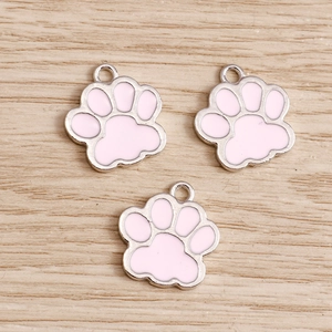 Detailed view of pink enamel cat paw alloy pendants with silver base for DIY jewelry