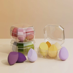 Detail view of colorful makeup sponge set with slanted and teardrop shapes in a clear case