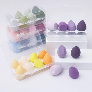 Close-up of multicolored teardrop makeup sponges in a transparent 8-compartment storage box