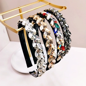 Detailed macro shot of four sparkling crystal headbands on a golden stand
