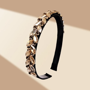 Detail of luxury headband featuring champagne marquise crystals on a black frame