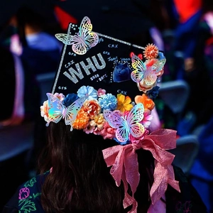 3D hollow iridescent butterfly stickers on a graduation cap with colorful flowers