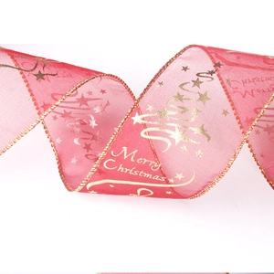 Detail view of red sheer Christmas ribbon with gold Merry Christmas print and wired edges