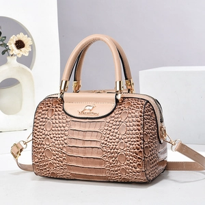 Elegant beige crocodile pattern handbag with glossy finish and gold-tone hardware detail
