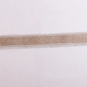 Macro detail of burlap ribbon with white lace trim for Christmas DIY craft gift wrapping