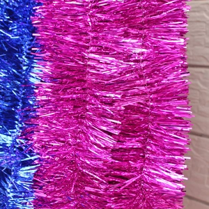 Close-up of shiny 2m pink and blue Christmas tinsel garlands with metallic fringe detail