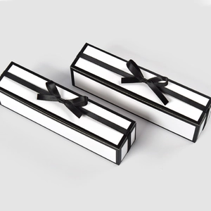 Rectangular white gift box with black ribbon and bow for jewelry or stationery packaging