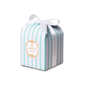 Detail of mint green striped gift box with gold floral frame and a white ribbon bow