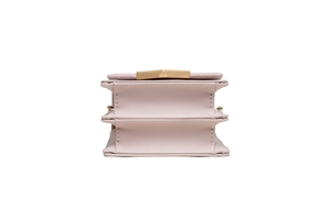Close-up of pink crossbody bag showing accordion pleat structure and fine stitching