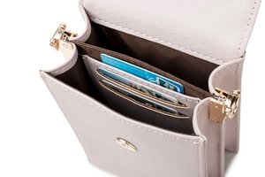 Detail of crossbody phone bag showing three card slots and secure magnetic closure