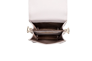 Detail view of white crossbody bag featuring dual compartments and gold metal hardware